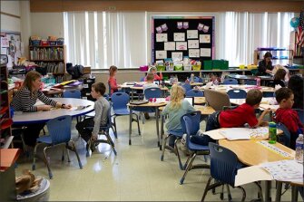 As a co-teaching team, Eisinger, far right, and 1st grade teacher Ritz use different strategies from day to day and lesson to lesson in serving the diverse needs of their students.