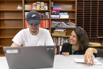 Teacher Joanne Reamy works with Benjamin Hain, 18, during an after school program at Mountain Education Charter High School in Woodstock, Ga. The Mountain Education Charter High School system has a program that pairs struggling students with adults who have faced similar challenges.