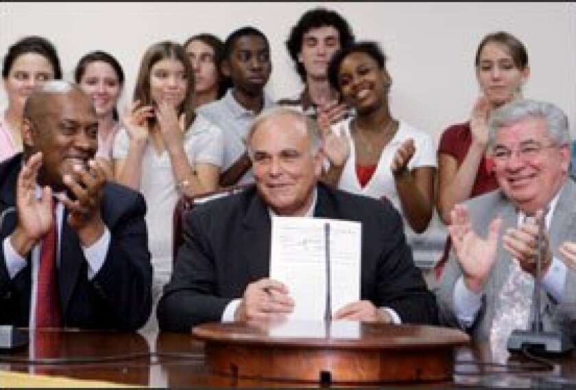 Gov. Ed Rendell displays the bill increasing state education funding. Flanking him at the July 8 signing ceremony at Upper Darby High School are state Rep. Dwight Evans, D-Philadelphia, left, and state Rep. Mario Civera, R-Delaware County.