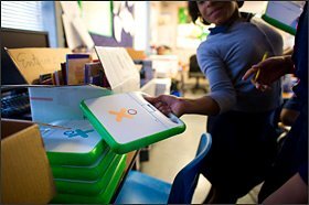 A student reaches for a laptop computer at the Chester Community Charter School. Part of the Chester Upland district, the school enrolls 3,100 students—nearly as many as the district's regular schools.