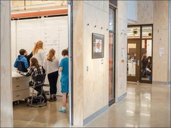 Inside the open floor plan school, students work together on algebra problems at the Science and Math Institute.