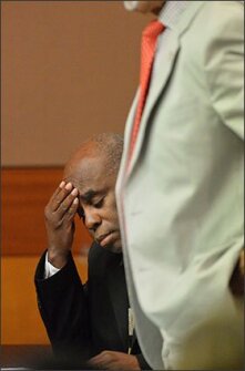 Former testing coordinator Donald Bullock holds his head as his defense attorney, Hurl Taylor, accepts a sentencing deal last week. Bullock avoided prison time but was sentenced to five years probation, six months of weekends in jail, a $5000 fine, and 1,500 hours of community service.