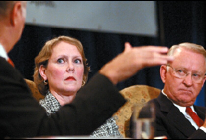 Moderator David R. Gergen gestures during a panel discussion on workforce preparation with Melanie Holmes, a senior vice president of Manpower Inc., and U.S. Rep. Howard P. "Buck" McKeon.