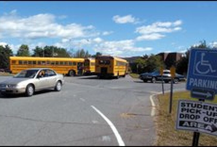 A student driver leaves the parking lot at Stafford High School in Stafford Springs, Conn., where the district raised the parking fee from $2 to $100 this school year.