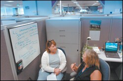 Working it Out: Teacher Mary Flodin, right, confers with Jodi Williamson, her peer coach from the Industry Initiative for Science and Math Education summer-externship program, at the offices of the Intel Corp. in Santa Clara, Calif. Ms. Flodin is one of 21 teachers in the program who are working at the Silicon Valley technology giant this summer.