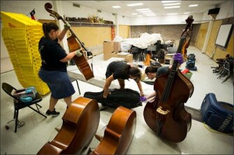 Staff at Thompson Intermediate School in Houston assess whether musical instruments can be salvaged.