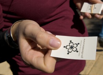Ms. Moody, hands out temporary tattoos to parade-goers in an effort to raise awareness of—and find students for—the new charter school.