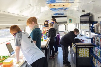 Students at Harrison Middle School are engrossed in projects and activities provided by the GOBSmobile, a mobile learning library for local kids, on Jan. 24, 2022. The school bus takes its' name from the Harrison School District mascot, the Goblins.