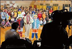 Brenda Considine, center, the principal of Providence Elementary School in Winchester, Ky., talks to a television reporter about Funky Dress-Up Day, a school effort to raise tsunami-relief money.