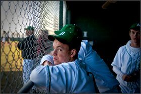 Dixon High School baseball players watch from their dugout during a game. The local school district is considering the elimination of all sports programs at the middle and high school, which now cost about $250,000 annually.