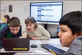 Math teacher Kathy Healy works with 6th grade students at Nathan Hale. Although students’ playlists are driven by algorithms, teachers on the ground have final say on the daily classroom assignments.