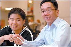 YouthFriends volunteer Minh Le, right, works with a Vietnamese student from Overland Park, Kan.