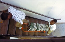 On their first day back to school after Hurricane Katrina, Walter Bailey, left, and Tyrone Andrew, both sophomores at Bonnabel High School, move history books that were salvaged from a building that was damaged in the storm.