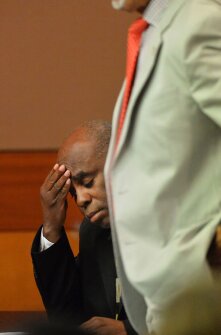 Former testing coordinator Donald Bullock holds his head as his defense attorney, Hurl Taylor, accepts a sentencing deal on April 14 in Atlanta. Bullock was sentenced to 5 years probation, 6 months of weekends in jail, a $5,000 fine, and 1,500 hours of community service. All but one of 10 former Atlanta public school educators convicted in a widespread conspiracy to inflate student scores on standardized tests were sentenced to jail time. Another defendant convicted in the case will be sentenced later this year.