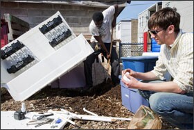 CCA Academy student John Crooks, left, works with Jason Axt, a design engineer, to create his own aquaponics system using a bathtub salvaged from the recycling center, a soda crate, and soda bottles. Aquaponics, which combines raising fish with growing food, has captivated numerous students at the school and engaged them in science.