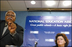 Union President Reg Weaver addresses a reporter's question at the National Press Club last week, while Kathryn Brown, a senior vice president of Verizon, listens.