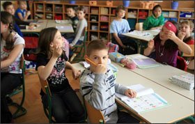 Filip Fisteski works on a math assignment with Izabela Milanez, left, and Anna Golob Doneva in Majda Jurkovic’s 4th grade class at Toneta Cufarja Elementary School in Ljubljana, Slovenia. Using the Step by Step method, teachers often group students to do classwork.