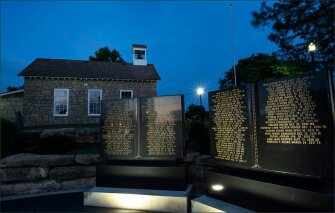 A stone schoolhouse from the 1800s sits above the Memorial to Fallen Educators at Emporia State University in Emporia, Kan. The monument to school employees who’ve died on the job was rededicated as a national memorial in June.