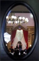 Through the oval window on the main entrance to the House chamber, Gov. Ted Strickland is seen as he delivers his third State of the State address Jan. 28 in Columbus, Ohio.