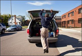 Reginald Cureton, a Detroit 7th grader who was found to have high lead levels in his blood at age 1, closes the hatch on his family’s car after school lets out at the Detroit Merit Academy. A new study links widespread lead poisoning in the district to lower achievement.