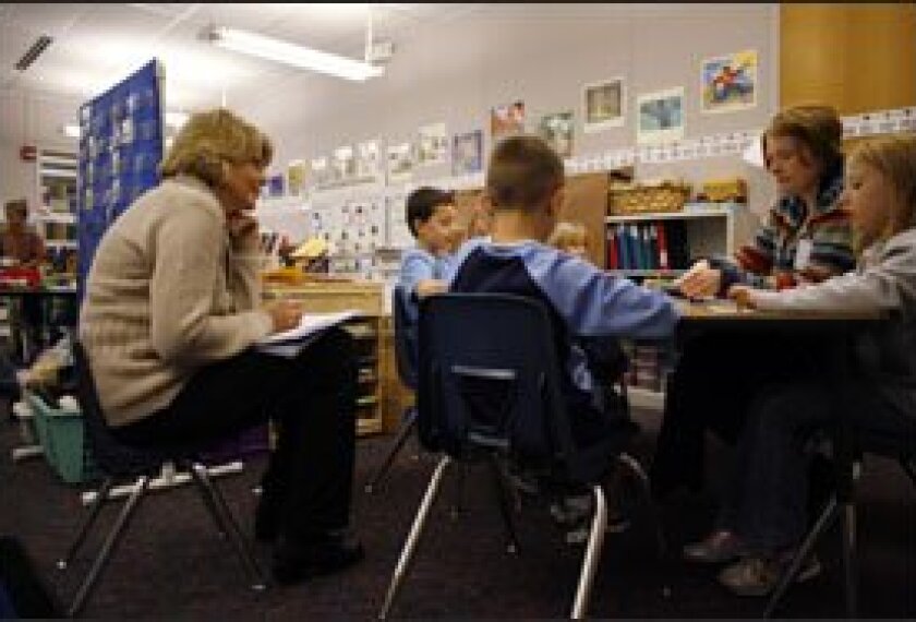Literacy coach Nancy McLean, left, takes notes while observing 1st grade teacher Charity Haviland working with students on a reading lesson at North Star Elementary.