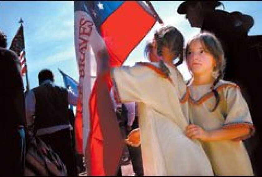 Hope Gamble, left, a 1st grader and Cherokee Indian from Webber Falls, Okla., and her sister, Destiny, a 2nd grader, march with their tribe in the Native Nations Procession during the opening ceremonies for the National Museum of the American Indian Sept. 21 in Washington.