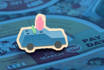 Illustration of game pieces landing on "Job Search" in The Game of Life. 