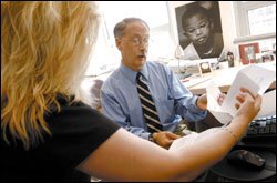 Researcher John W. Fantuzzo, shown with a colleague in his University of Pennsylvania office, helps run a comprehensive database on Philadelphia's children.