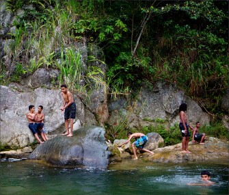 Children from the La Joya, Jarabacoa, community and Chicago’s Village Leadership Academy swim downstream from the Jimenoa Waterfall in the Dominican Republic.