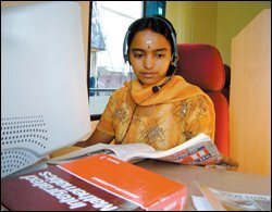Sitting at her computer in Kochi, India, Bindu Sudheep uses headphones, a pen mouse, and a writing tablet to tutor Darrow Feldstein, a 10th grader at Beverly Hills High School in California. The fee for the service is about a third of the cost for tutors stateside.
