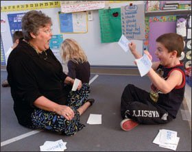Chets Creek Elemntary School literary coach Dayle Timmons (left) plays "Go Fish" using plural cards with 1st grader Dominik Klemestrud, 6, in Jacksonville, Fla.