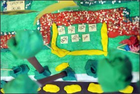 A different group of students displays its working model for the school facade project.