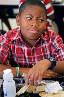 Kenmari Williams, a 5th grader in Clinton, Miss., shows his dislike of the whole-wheat flatbread on his sandwich, one of the healthy changes his school has made to lunches under new federal school meal rules.
