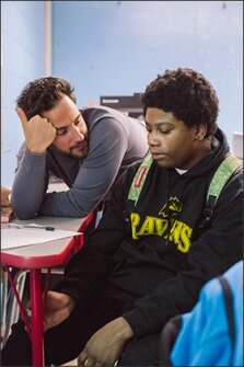 Brandon Cardet-Hernandez completed a program that trained him in how to spot inequities and find solutions to address them. Here, Cardet-Hernandez talks to 8th grader Matthew Paynes.