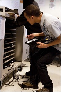 Kevin Keane, 17, returns a netbook to a computer storage cart at the end of an Advanced Placement U.S. Government class at the East Bronx Academy for the Future in New York City.