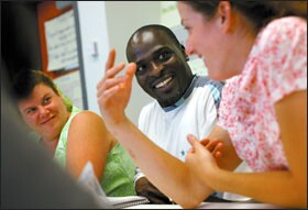 Terrell Williams, center, works with fellow first-year teachers Dawn Fowler, left, and Renee Fisher at a new-teacher institute in Baltimore. Mr. Williams entered the New Teacher Project after 20 years in retail management.