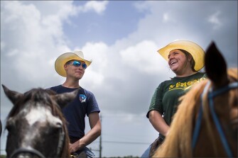 Kristi Helton of the Galveston County Mounted Posse accompanied by Wesley Willoughby, left, share a smile during the Santa Fe High School’s class of 2008 reunion fundraising event.