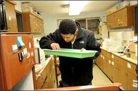 Andro checks his radish seed experiment in science class. He is learning about the effects of temperature on the germination of seeds.