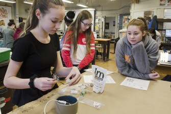 Ninth graders Angela Alexy, Zoe Doyle, and Sarah Retallick use Instamorph to mold a custom phone cord holder at Pennsbury High School in Falls Township, Pa., on March 19, 2018. Bucks County schools are involving girls in STEM programs.