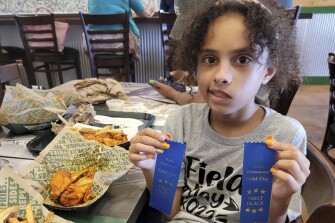 In this image provided by Vincent Salazar, Layla Salazar poses with her first place ribbons from field day at her school, Robb Elementary School. Layla was one of the 19 children and their two teachers who were gunned down behind a barricaded door at Robb Elementary School in Uvalde, Texas.
