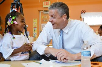 Then-U.S. Education Secretary Arne Duncan visits with students at the St. Benedict Center for Early Childhood Education in Louisville, Ky., in June 2013. Duncan spearheaded Obama administration education initiatives.