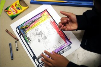 Jasen, a kindergartener at Wheeler, draws what he would like to see fall from the sky.
