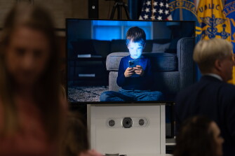 A video showing child screen use is pictured in the Hubert Humphrey Building in Washington on Sept. 1, 2026. The U.S. Department of Health and Human Services (HHS) Convenes Leaders at Live Real Life Symposium to Address Harms of Screen Use in Children. The symposium is part of HHS’s Live Real Life campaign, a national effort aimed at helping families, schools, and communities reduce harmful screen use and create more opportunities for children to engage in the experiences essential to healthy development.