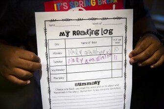 Carter Aikin, 8, shows off his summer reading log in the family’s home in Katy, TX, on Thursday, July 8, 2021.