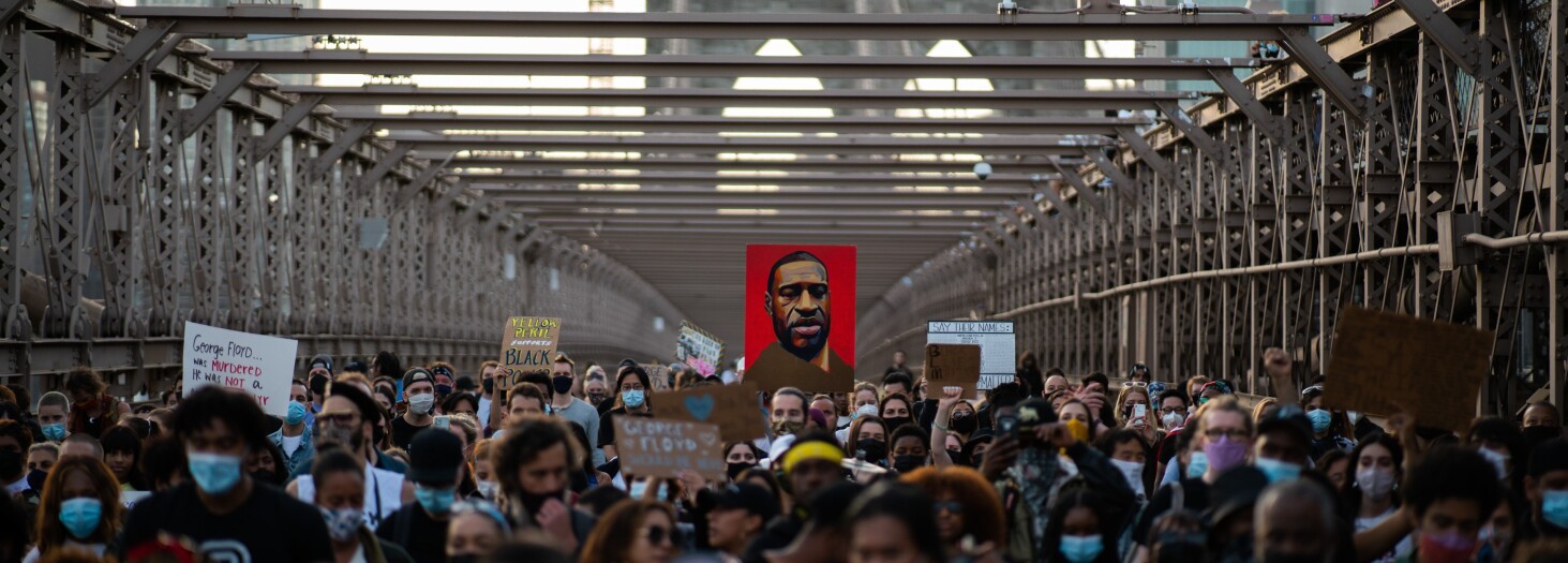 Demonstrators march across the Brooklyn Bridge as they remember George Floyd on the one-year anniversary of his death, Tuesday, May 25, 2021, in New York.