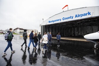 Students from Magruder High School’s aviation program visit the Montgomery County Airpark in Gaithersburg, Md., on April 6, 2022.