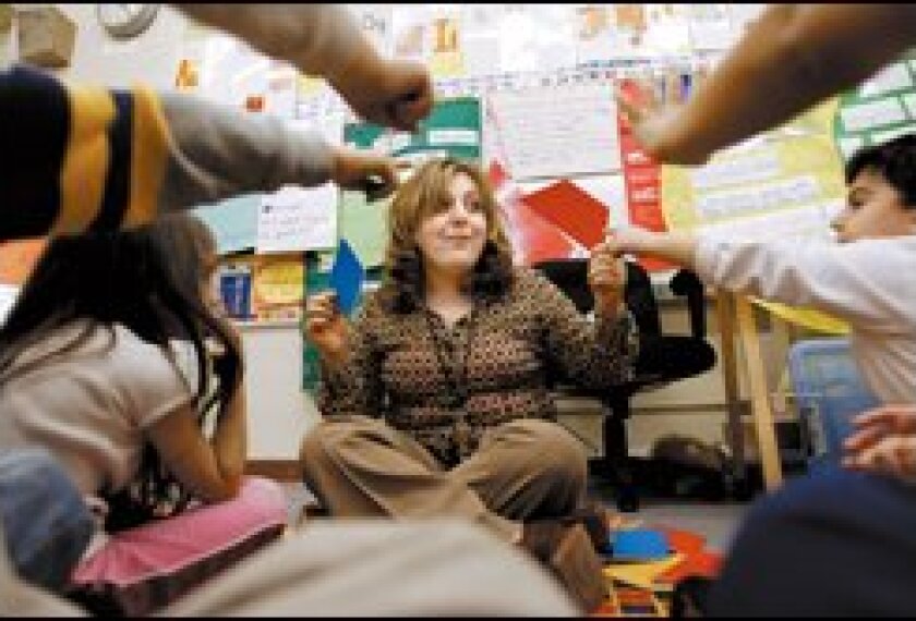 Kindergarten teacher Miriam Kupaliam reviews geometric shapes for a math lesson at Cheremoya Elementary School in Los Angeles. The school started full-day kindergarten classes last fall.