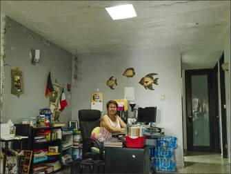 Zelideth Otero López, an English teacher at Guillermina Rosado De Ayala, sits for a portrait at her home in Loiza, Puerto Rico. Conditions at the school have some members of her family exploring the option of moving to places like Florida or Texas.