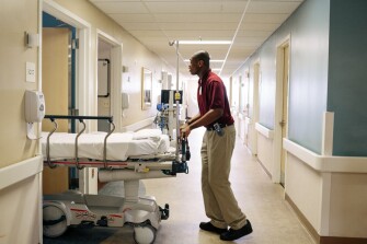 Project SEARCH intern Demetrius Wade, 18, waits to transport a patient.