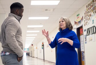 Waller speaks with DC Clemons, a media assistant who helps with Project Lift-Off. The summer enrichment program helps put students facing homelessness on firmer footing for the school year.